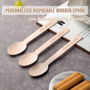 May include: Three wooden spoons with personalized text. The spoons are light brown and have rounded edges. The text on the spoons reads "Jack & Marry", "YOUR LOGO", and "YOUR TXT".