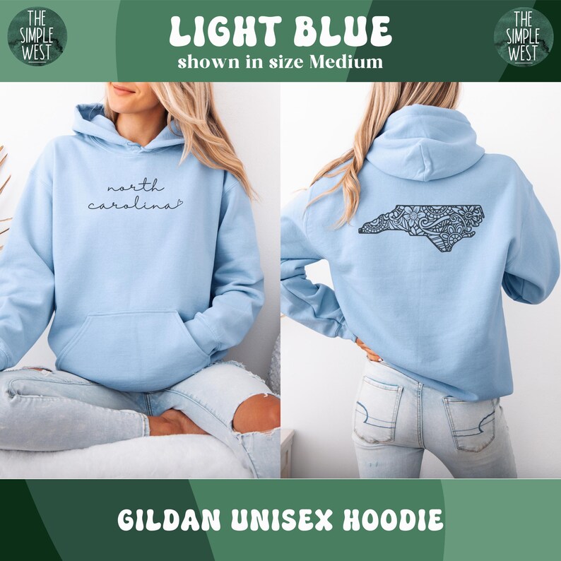 May include: Light blue Gildan unisex hoodie. The front features the text "north carolina" in a cursive font. The back displays a detailed black design of the North Carolina state outline. The hoodie is shown in size Medium.