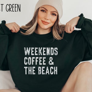 May include: Forest green sweatshirt with the text "Weekends Coffee & The Beach" in white distressed lettering.
