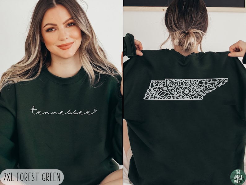May include: A forest green sweatshirt with the word "Tennessee" and a heart on the front. The back of the sweatshirt features a white outline of the state of Tennessee filled with a floral mandala design.