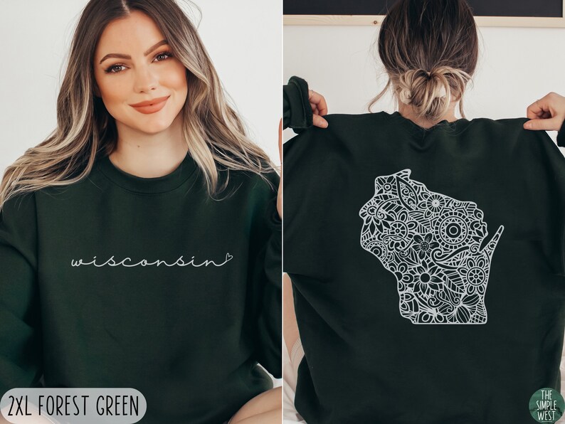 May include: A forest green sweatshirt with a white outline of the state of Wisconsin filled with a floral pattern on the back. The front of the sweatshirt has the word "wisconsin" written in white cursive with a small heart after the word. The text "2XL FOREST GREEN" is at the bottom of the image.