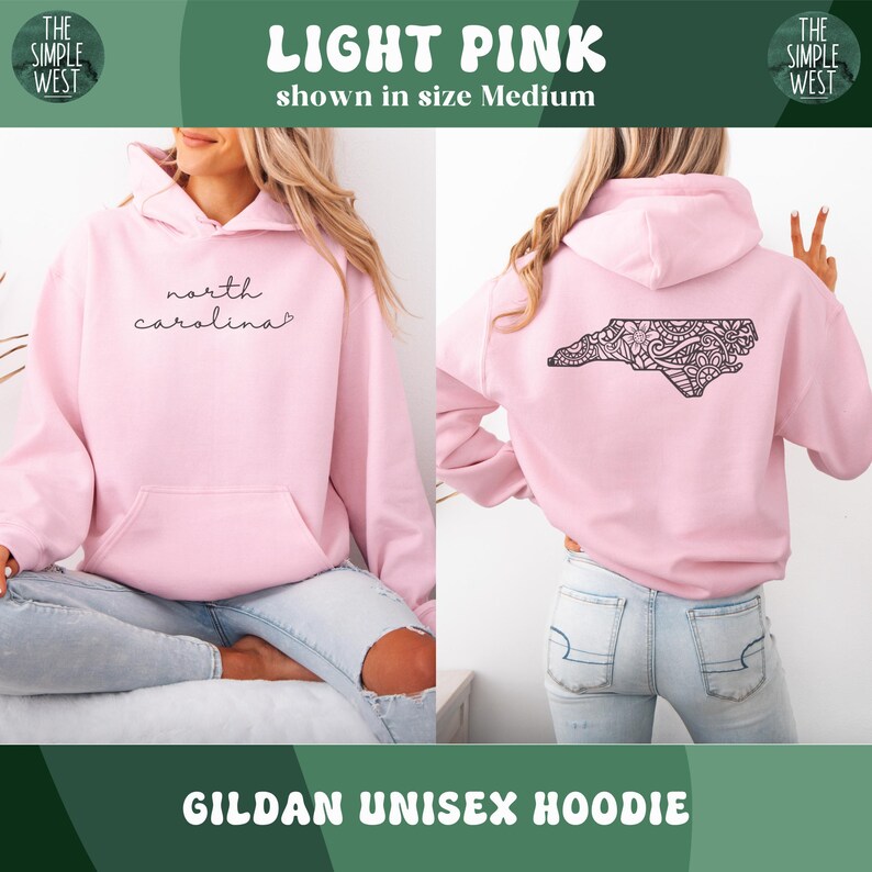 May include: Light pink Gildan unisex hoodie. The front features the text "north carolina" in a cursive font. The back displays a black, detailed outline of North Carolina. The hoodie is shown in size medium.