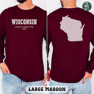 May include: Maroon long-sleeve shirt with the word "WISCONSIN" printed on the front, along with "Andrew's Family Trip 2025". The back of the shirt features a light purple outline of the state of Wisconsin. The shirt is labeled "LARGE MAROON".