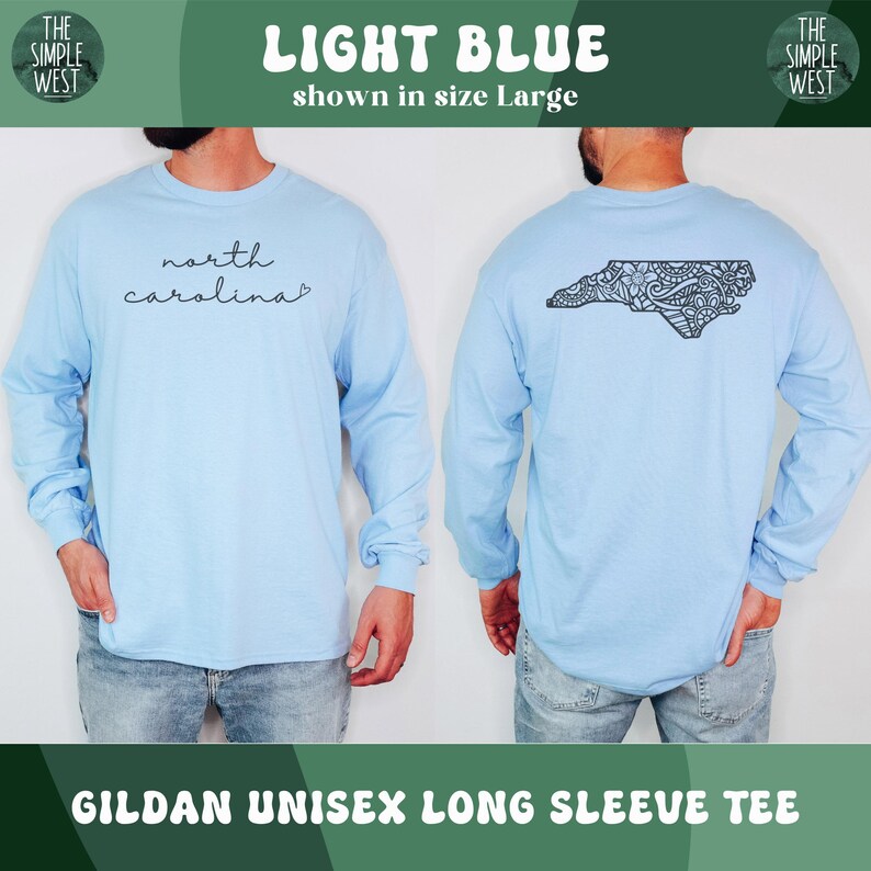 May include: Light blue Gildan unisex long sleeve tee. The front of the shirt has the words "north carolina" in a cursive font. The back of the shirt has a black graphic of the state of North Carolina. The shirt is shown in size Large.