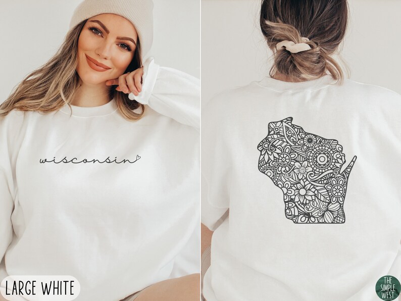 May include: White sweatshirt with the text "wisconsin" in black script on the front and a black and white mandala-style outline of the state of Wisconsin on the back. The sweatshirt is available in size large.