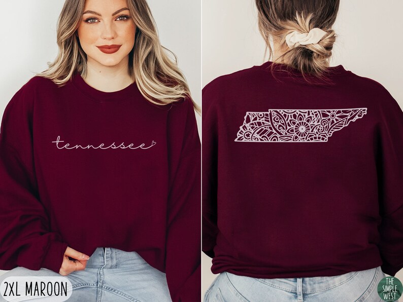 May include: A maroon sweatshirt with the word "Tennessee" in white script on the front and a white outline of the state of Tennessee with a floral design on the back.