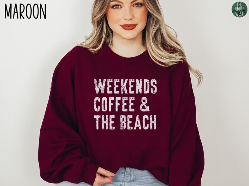 May include: A maroon sweatshirt with the text "Weekends Coffee & The Beach" in white distressed lettering.