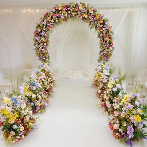 Whimsical Floral Arch with Aisle Meadow Arrangements: Pastel Wedding Ceremony Backdrop
