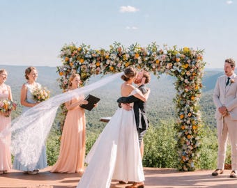 Wildflower Wedding Arbor Arrangements in Pastel Palette with a Splash of Orange and Light Blue