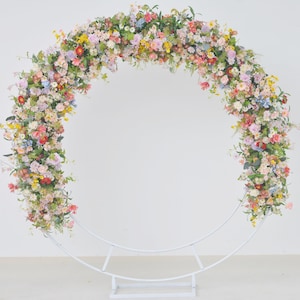 Wildflower Wedding Arrangements in a Pastel Palette with a Splash of Yellow and Light Purple for a Round Arbor.