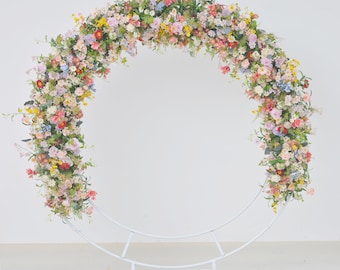 Wildflower Wedding Arrangements in a Pastel Palette with a Splash of Yellow and Light Purple for a Round Arbor.