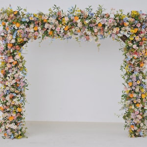 Wildflower Wedding Arbor Arrangements in Pastel Palette with a Splash of Orange and Light Blue