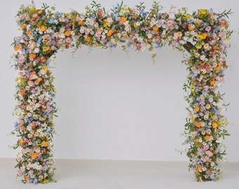 Wildflower Wedding Arbor Arrangements in Pastel Palette with a Splash of Orange and Light Blue