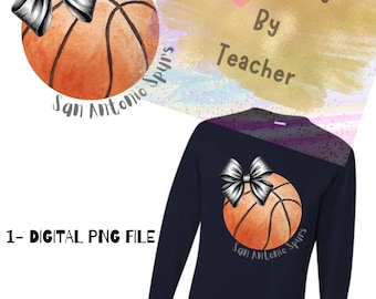 May include: Navy blue long-sleeve shirt featuring a basketball graphic with a silver bow and the text "San Antonio Spurs". The image also includes a digital PNG file graphic of the basketball and bow.
