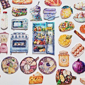 May include: A collection of colorful, glittery stickers featuring kitchen appliances, food, and other household items. The stickers include a refrigerator, oven, blender, and a variety of food items like bread, cheese, and fruit.