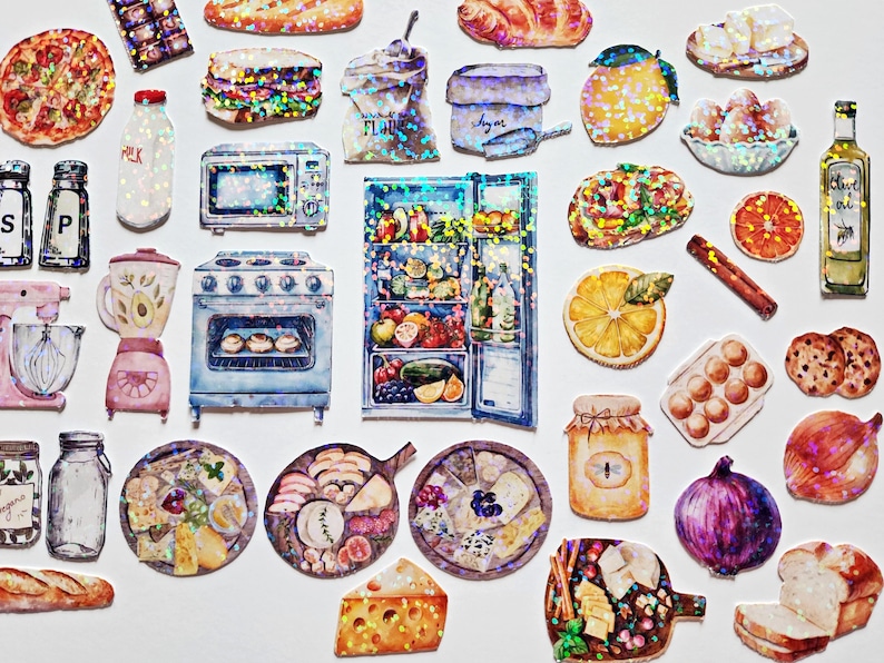 May include: A collection of colorful, glittery stickers featuring kitchen appliances, food, and other household items. The stickers include a refrigerator, oven, blender, and a variety of food items like bread, cheese, and fruit.