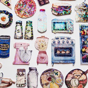 May include: A set of 18 holographic stickers featuring kitchen-themed illustrations. The stickers include a pizza, a frying pan, a blender, a mixer, a stove, a refrigerator, a microwave, a loaf of bread, a jar of spices, a jar of baking powder, a jar of oregano, a jar of milk, a jar of flour, a sandwich, and a plate of cheese and crackers.
