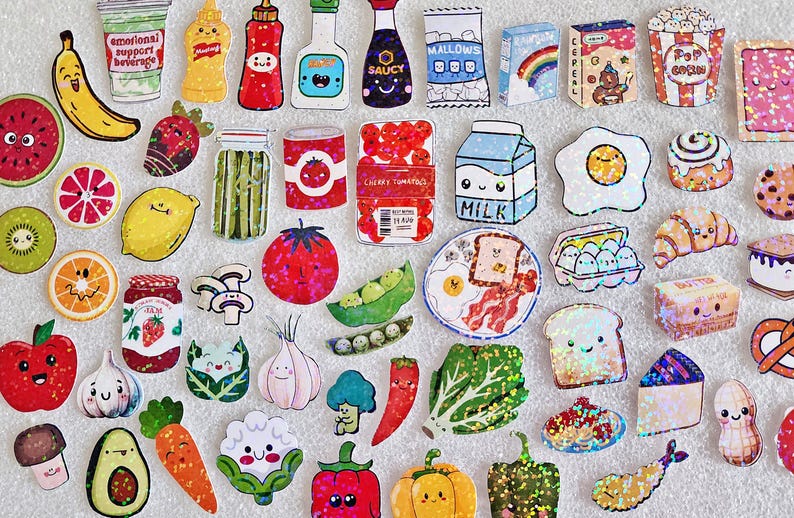 May include: A collection of colorful, illustrated food stickers, including fruits, vegetables, condiments, and breakfast items. The stickers feature smiling faces and playful designs, such as a banana, watermelon, and a carton of milk. The text "emotional support beverage" is visible on a cup.