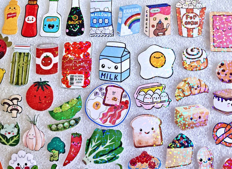 May include: A collection of colorful food-themed stickers, including a carton of milk, a fried egg, a slice of toast, and a plate of bacon and eggs. Other stickers include popcorn, cereal, and various vegetables.