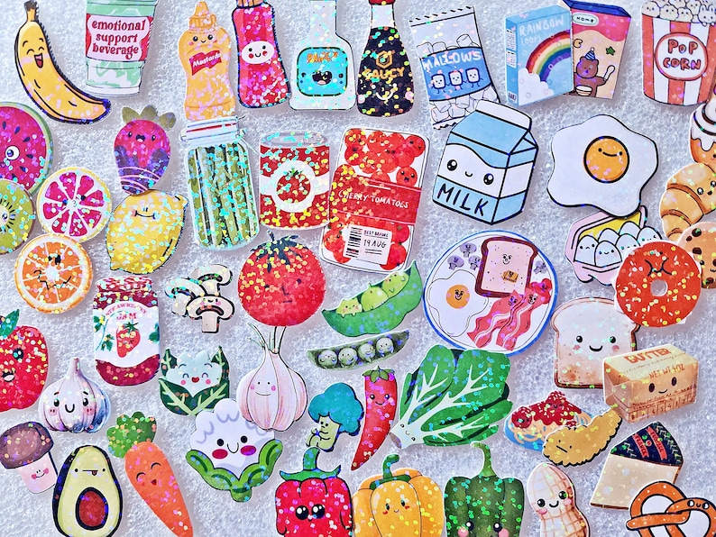 May include: A collection of colorful food-themed stickers, including a banana, milk carton, egg, tomato, and various fruits and vegetables. The stickers have a cartoon style with smiling faces and bright colors. The stickers are arranged on a white surface.