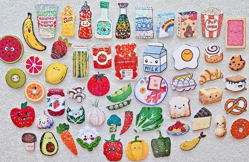 May include: A collection of colorful, cartoon-style food and drink stickers, including a banana, watermelon slice, milk carton, egg, and popcorn. The stickers have a glittery effect and smiling faces.