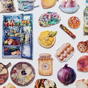 May include: A collection of colorful, glittery stickers featuring various food items, including a refrigerator, a jar of honey, a loaf of bread, a bowl of eggs, a plate of cheese, and a lemon. The stickers are perfect for adding a touch of whimsy to planners, journals, and other craft projects.