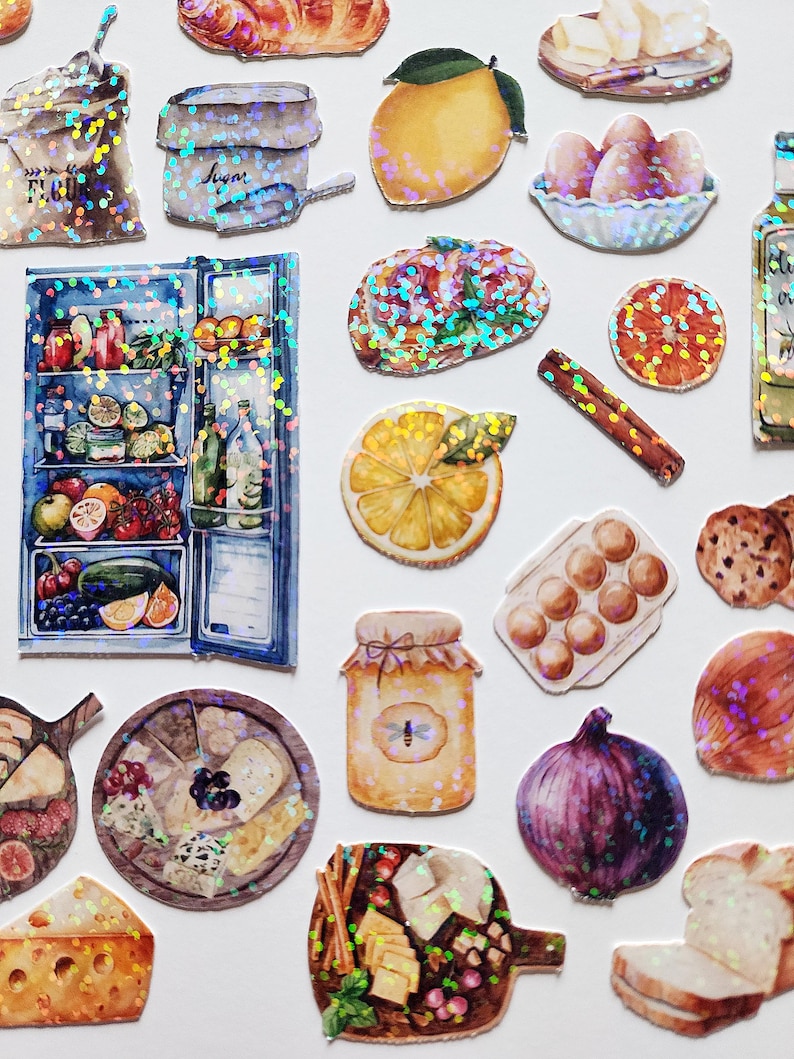 May include: A collection of colorful, glittery stickers featuring various food items, including a refrigerator, a jar of honey, a loaf of bread, a bowl of eggs, a plate of cheese, and a lemon. The stickers are perfect for adding a touch of whimsy to planners, journals, and other craft projects.