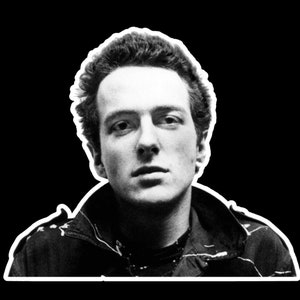 May include: Black and white portrait of a man with short, spiky hair. He is wearing a dark jacket with a zipper.