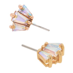 May include: A pair of gold earrings with iridescent crystal accents. Each earring features a cluster of five crystals in a geometric shape.