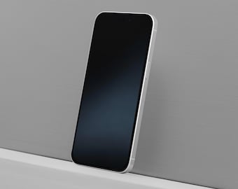 Peut inclure: Un smartphone argenté avec un écran noir, appuyé contre un mur gris. L'écran du téléphone est sombre et les bords sont argentés. Le téléphone est légèrement incliné, mettant en valeur son design épuré.