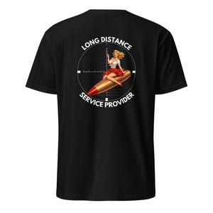 May include: Black t-shirt featuring a graphic of a woman riding a bullet, inside a scope, with the text "LONG DISTANCE SERVICE PROVIDER". The woman is wearing a white top and red skirt.