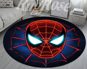 May include: A round rug with a blue background and a red and black Spider-Man mask in the center. The mask has white eyes and a web design.