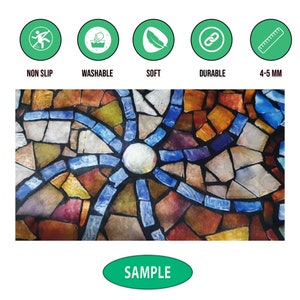 May include: A close-up of a colourful stained glass window with a circular pattern in the centre. The glass is made up of small, irregular pieces of glass in shades of blue, red, yellow, and green. The window is framed in black metal.