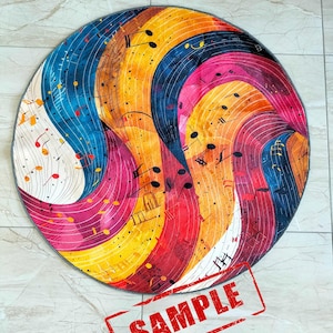 May include: Round rug with a colorful abstract design featuring musical notes and swirls of blue, yellow, pink, and red. The rug has a gray border and the word "SAMPLE" is stamped in red on the bottom right corner.