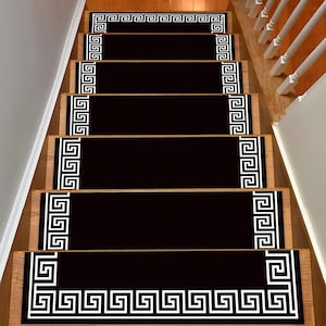 May include: Black and white patterned stair treads with a geometric design. The treads are made of a soft, non-slip material and are perfect for adding a touch of style to any staircase.