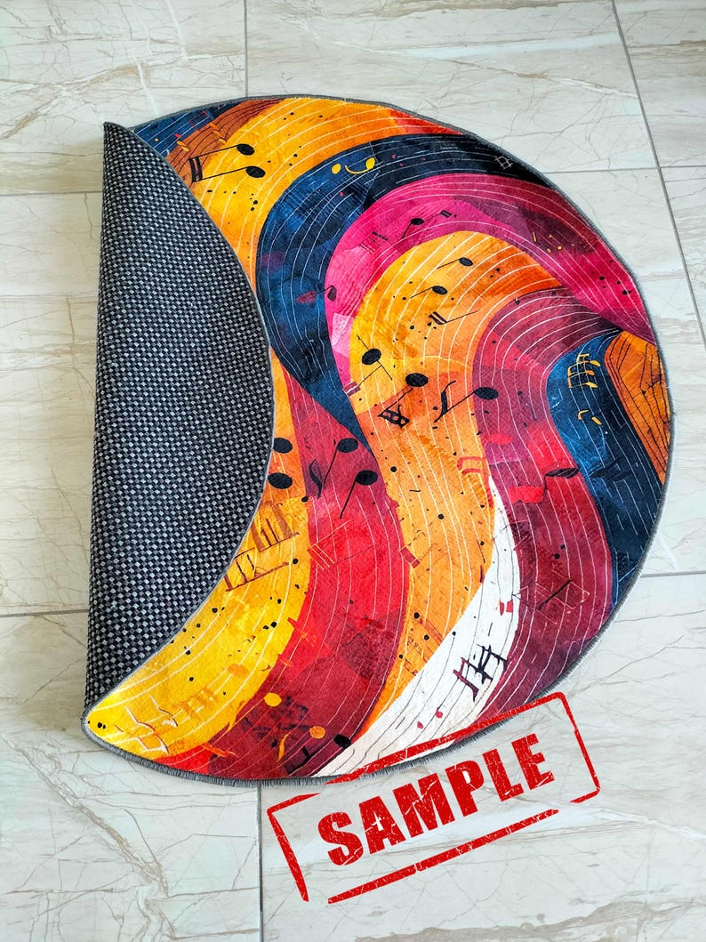 May include: A colorful round rug with a musical note design. The rug has a gray backing and is rolled up. The rug has a red stamp that says "SAMPLE".
