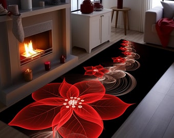 Op de afbeelding: Een zwart rechthoekig vloerkleed met een groot, gestileerd rood poinsettia bloemmotief. Het vloerkleed heeft een herhalend bloemenpatroon met witte en rode accenten. Het vloerkleed ligt voor een open haard.