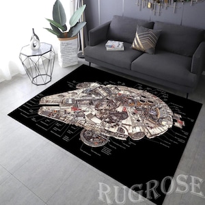 May include: A black and white area rug featuring a detailed illustration of the Millennium Falcon spaceship. The rug has white outlines and text surrounding the spaceship.