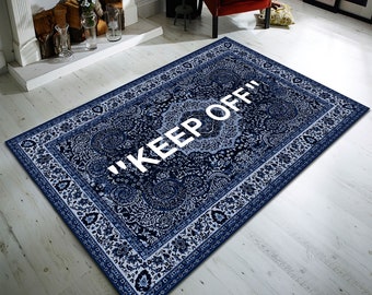 May include: A blue and white patterned rug with a white inscription that reads "KEEP OFF".