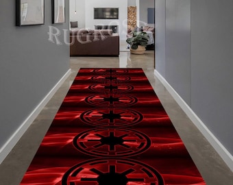 May include: A red runner rug with a repeating pattern of black Imperial symbols from Star Wars. The rug is in a hallway with white walls and a wooden floor.