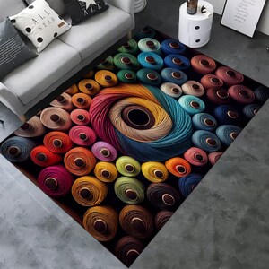 May include: A colorful rug with a design of many spools of thread in various colors, including red, blue, green, yellow, and brown. The spools are arranged in a circular pattern, creating a visually appealing and textured design.