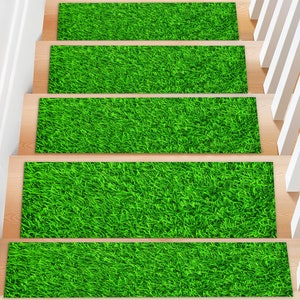 May include: Five green grass-like stair treads with a brown wood backing. The treads are designed to look like artificial grass.