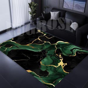 May include: Abstract area rug with a black, green, and gold marble design. The rug has a modern and contemporary style.