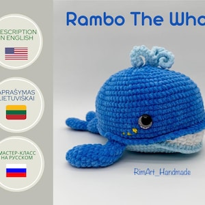 May include: A crocheted blue whale toy with a white belly and a light blue swirl on top. The toy has a black eye and a yellow mouth. The text "Rambo The Whale" is written in white above the toy. The text "RimArt_Handmade" is written in black below the toy.
