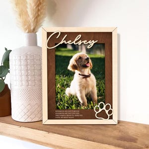 May include: A wooden photo frame with a light brown background and a paw print cutout. The frame has a photo of a golden retriever puppy and the name "Chelsey" written in cursive. The text below the photo reads "Goodbyes are not forever, Goodbyes are not the end, They simply mean I'll miss you until we meet again."