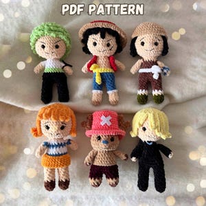 May include: Six crocheted dolls with distinct character designs. The dolls have different hair colours, outfits, and accessories. The image includes the text "PDF PATTERN" at the top.