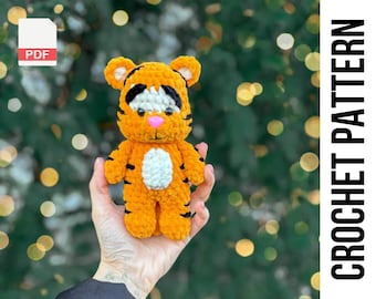 May include: A crochet pattern for a cute orange and black tiger amigurumi toy. The pattern is available as a PDF download.