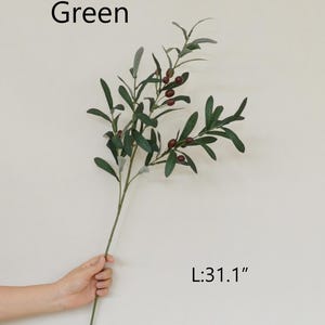 May include: Green artificial olive branch with small dark red berries. The branch is 31.1 inches long.