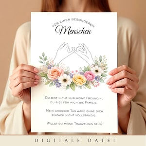 May include: A white card with text in German, held by a person. The card features a floral design with pink, yellow, and white flowers. The text includes phrases like "Für einen besonderen Menschen" and "Willst du meine Trauzeugin sein?"