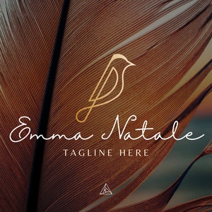 May include: A minimalist logo design featuring a stylized bird in gold with the text "Emma Natale" and "TAGLINE HERE" in white script font against a background of a brown feather.